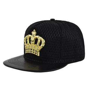 Close-up of golden crown metal emblem on black mesh trucker hat with faux leather brim