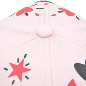 Pink graffiti baseball cap featuring red heart and star patterns in a top-view detail