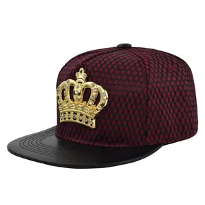 Detail of burgundy mesh hip hop cap with gold crown emblem and black leather brim