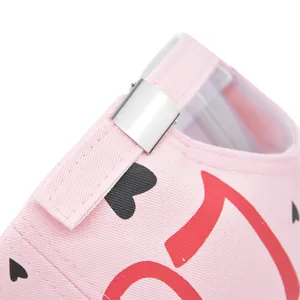 Close-up of pink graffiti baseball cap back with silver metal buckle and heart print