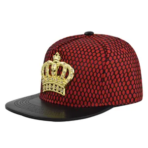 Close-up of golden crown emblem with rhinestones on hip-hop trucker cap with mesh texture