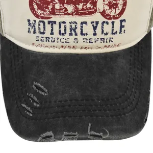 Detail of vintage motorcycle cap featuring distressed grey brim and canvas print