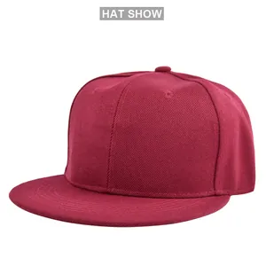 Close-up of wine red flat brim baseball cap showing cotton twill fabric and stitching