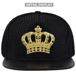 Close-up of golden crown emblem with rhinestones on a black mesh snapback cap