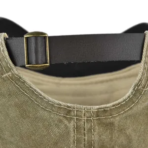 Detail of adjustable brown leather strap and bronze metal buckle on the baseball cap