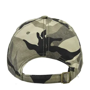 Detail view of adjustable metal buckle and woodland camouflage fabric on a tactical cap