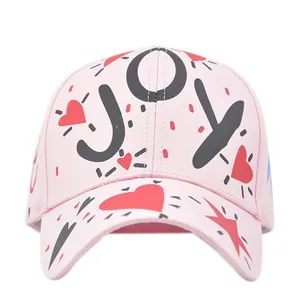 Pink graffiti baseball cap with black JOY print, red heart and stars on curved brim