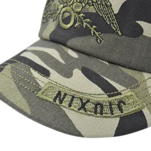 Detailed macro view of camo military cap featuring eagle embroidery and reinforced stitching