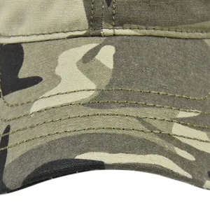 Close-up of jungle camouflage baseball cap fabric with reinforced brim stitching
