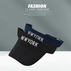 Detail of NEW YORK embroidery on black and navy sun visors with mesh back and adjustable strap