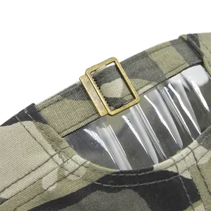 Detail of adjustable metal buckle and camouflage canvas strap on back of army cap