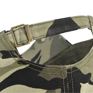 Close-up of adjustable bronze metal buckle and camo fabric on the back of the military cap