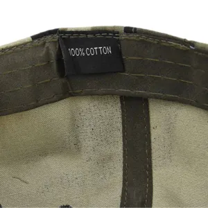 Detail shot of the internal 100% cotton label and stitching on a camouflage army cap