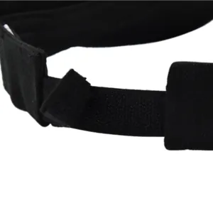 Detail of adjustable hook-and-loop strap on a black sports visor with durable fabric