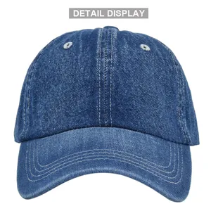 Close-up of washed blue denim baseball cap detail showing white eyelets and stitching