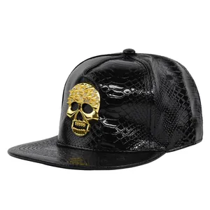 Close-up of black PU leather baseball cap with gold studded skull and snakeskin texture