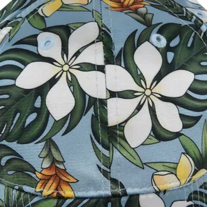 Floral baseball cap detail showing tropical leaf print and durable stitched eyelets