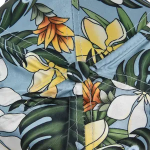 Macro shot of tropical floral embroidery and fine stitching on a blue baseball cap