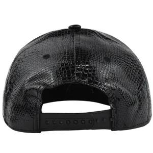Detail view of the black faux crocodile leather texture and snapback closure on hip hop hat