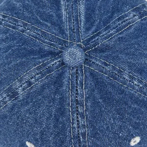 Detailed top view of blue denim baseball cap showing premium stitching and fabric
