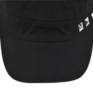 Detailed close-up of a black cotton military cap featuring silver square metal rivets