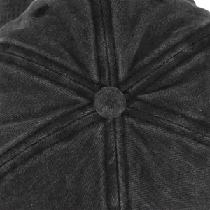 Close-up of the reinforced top button and stitched twill fabric on a gray baseball cap