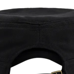 Detail of uniform stitching and metal adjustable buckle on black cotton military cap