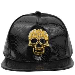 Hip hop style faux snakeskin baseball cap with large gold rhinestone skull on front