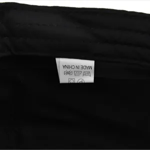 Macro view of the white care label with washing symbols inside a black military cap