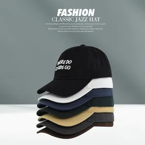 Close-up of stacked colorful cotton baseball caps featuring embroidered text detail