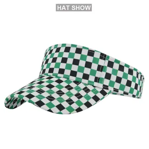 Close-up of checkerboard pattern sun visor hat with curved brim and green accents