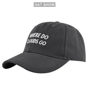 Detail view of dark grey baseball cap showing white embroidery and stitching