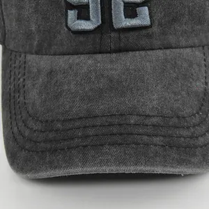 Macro detail of '92' patch embroidery on vintage washed cotton baseball cap