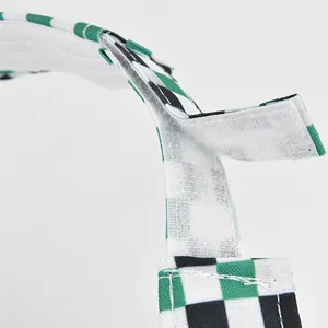 Checkered visor cap with adjustable velcro strap showing green and white canvas detail