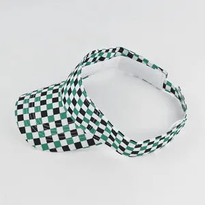 Detail view of the green checkered visor cap with adjustable white velcro strap closure