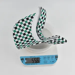 Detailed view showing the weight of green checkerboard sun hat at 55.6g on a digital scale