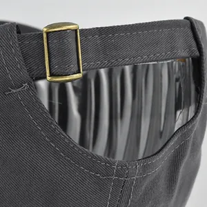 Detail view of cotton baseball cap with adjustable vintage brass buckle and stitching