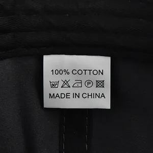 Detailed view of the 100% cotton wash label and fabric texture on a black baseball cap