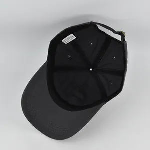 Detail view of the cotton baseball cap interior with wash label and adjustable strap