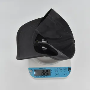 Detailed scale view showing the weight of a premium dark grey cotton baseball cap