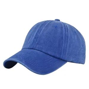 Detailed view of dark blue washed cotton texture and stitching on a classic baseball cap