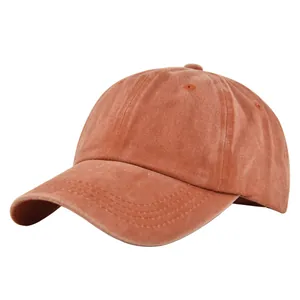 Close-up of vintage brick red washed cotton baseball cap with ventilation eyelets