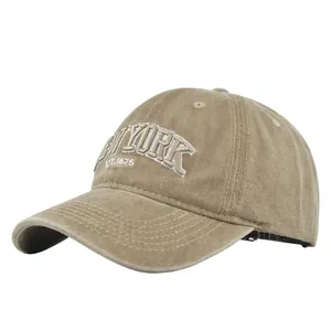 Detailed close-up of white 3D embroidery showing NEW YORK EST.1625 on khaki baseball cap