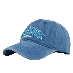 Detailed close-up of vintage washed denim baseball cap with New York embroidery