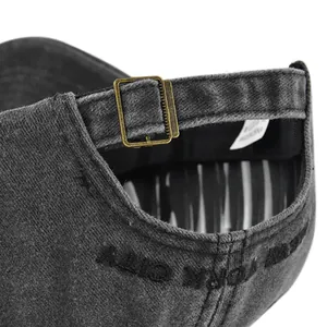 Detail of adjustable metal buckle and embroidery on washed cotton baseball cap