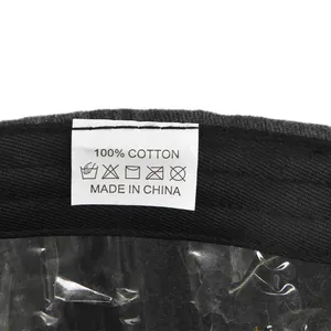 Detail showing 100% cotton material label and washing instructions on a baseball cap