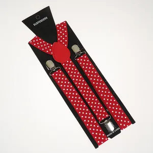 Detailed close-up of red and white polka dot elastic suspenders with metal clips
