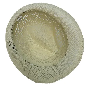 Close-up of hollow woven straw hat interior with sweatband and care label detail