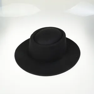 Detail view showing smooth matte texture and wide brim of black wool felt flat top hat