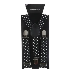 Detail of black polka dot suspenders with three silver metal clips on a display card